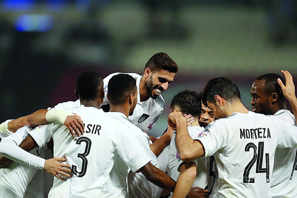 Al Sadd players celebrate after Jugurtha Hamroun scored their first goal against Al Rayyan in the Qatar Clasico at the Al Sadd Stadium yesterday. Al Sadd evened out with Al Rayyan in this season’s Qatar Clasico by registering a comfortable 2-0 victory in 