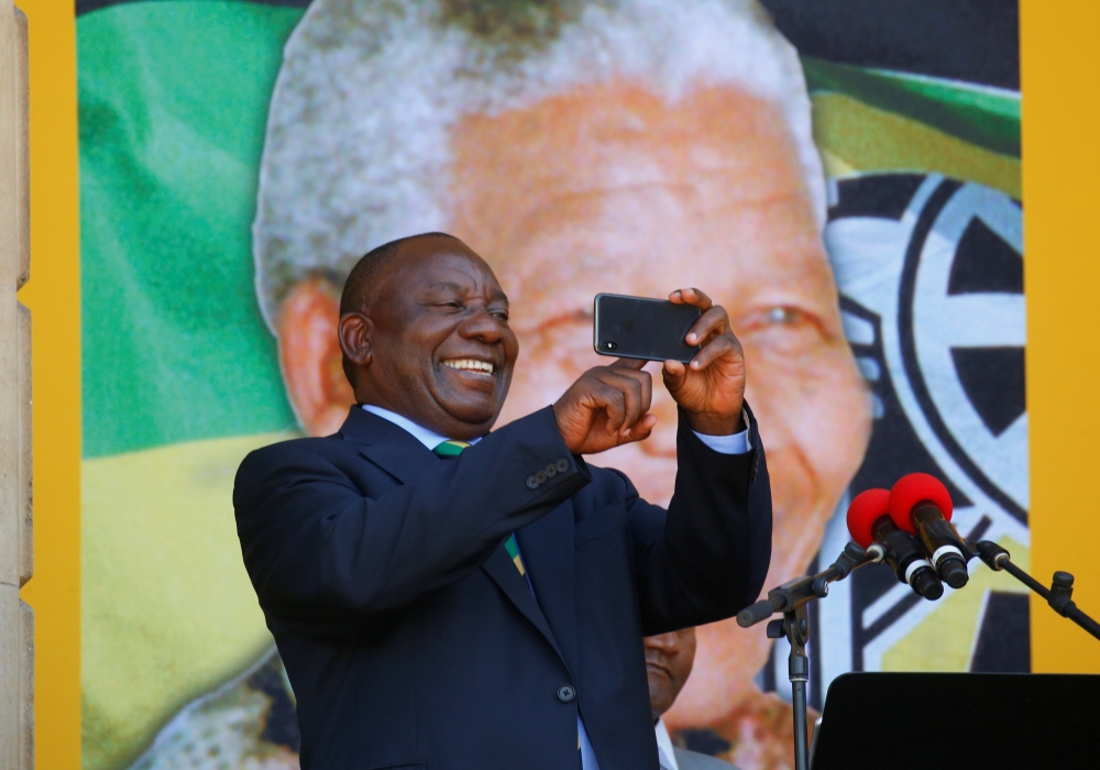 South African Deputy-President Cyril Ramaphosa use his phone during a rally to commemorate Nelson Mandela's centenary year in Cape Town, South Africa, February 11, 2018. Reuters/Mike Hutchings