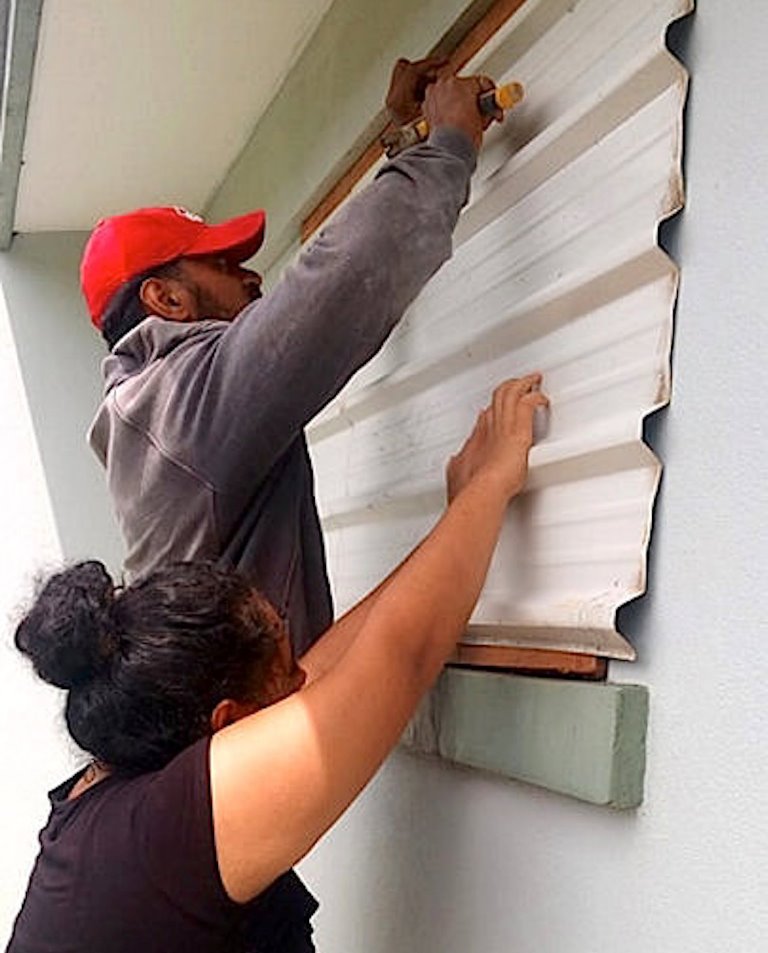 A supplied image shows locals covering windows to office buildings as part of preparations for Cyclone Gita in the tonga capital of Nuku'alofa, February 12, 2018. Taniela Hoponoa/CARE Australia/Handout via REUTERS 