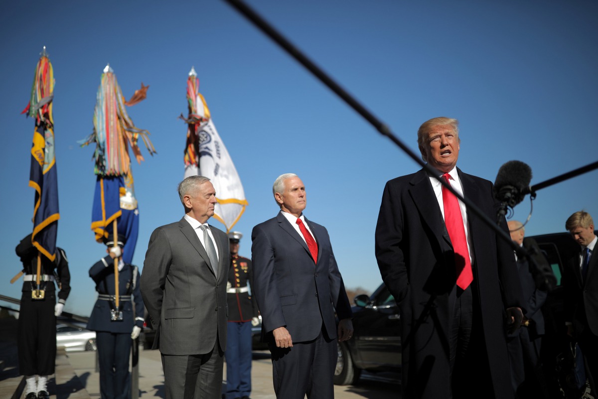 Donald Trump speaks to reporters as he arrives for a meeting at the Pentagon, accompanied by Defense Secretary Jim Mattis,  VP Mike Pence in Arlington, Virginia, January 18, 2018. Reuters/Carlos Barria