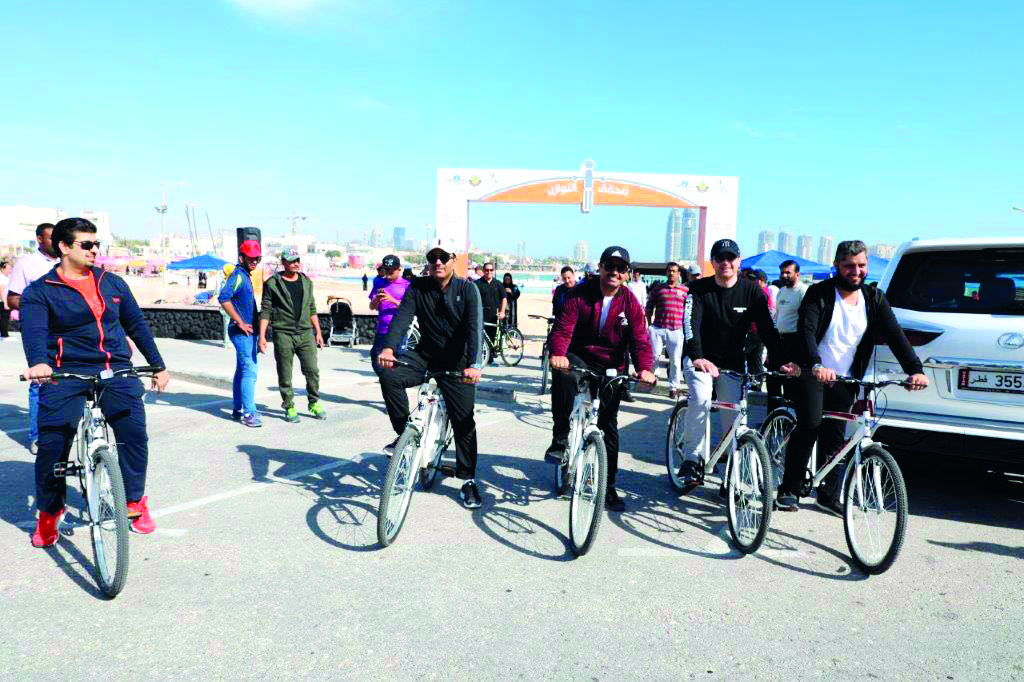 LEFT: Minister of Energy and Industry, H E Dr Mohammed bin Saleh Al Sada (third right) and President of Kahramaa, Issa bin Hilal Al Kuwari (fourth right) with other officials engage in cycling as part of National Sport Day celebrations. 