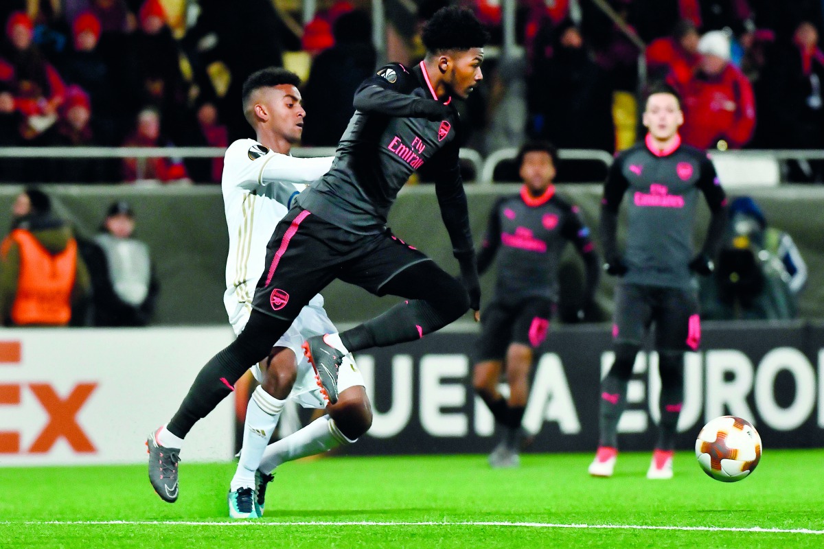 Arsenal's Ainsley Maitland-Niles (R) and Ostersund's Tesfaldet Tekie vie for the ball during the UEFA Europa League round of 32, first leg football match of Ostersund FK vs Arsenal FC on February 15, 2018 in Ostersund, Sweden.  AFP / TT News Agency / Robe