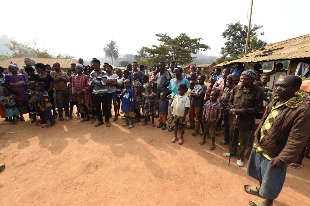 (FILES) This file photo taken on January 31, 2018, shows Cameroonian refugees, including women and children gathering for a meeting at Bashu-Okpambe village in Boki district of Cross Rivers State in Nigeria. AFP / PIUS UTOMI EKPEI