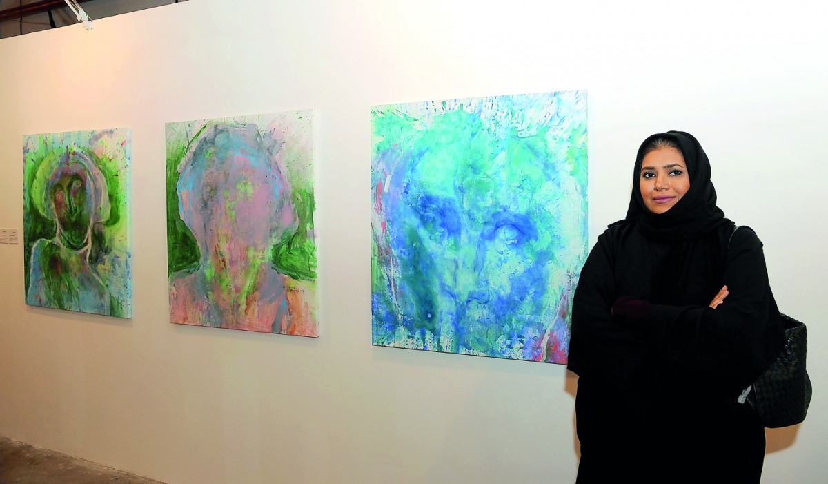 Qatari artist Ebtissam Al Saffar poses with her paintings at the opening of “Perspectives-Contemporary Arab Women Artists” at the Art 29 at W Hotel in Doha yesterday. Pic: Salim Matramkot/The Peninsula