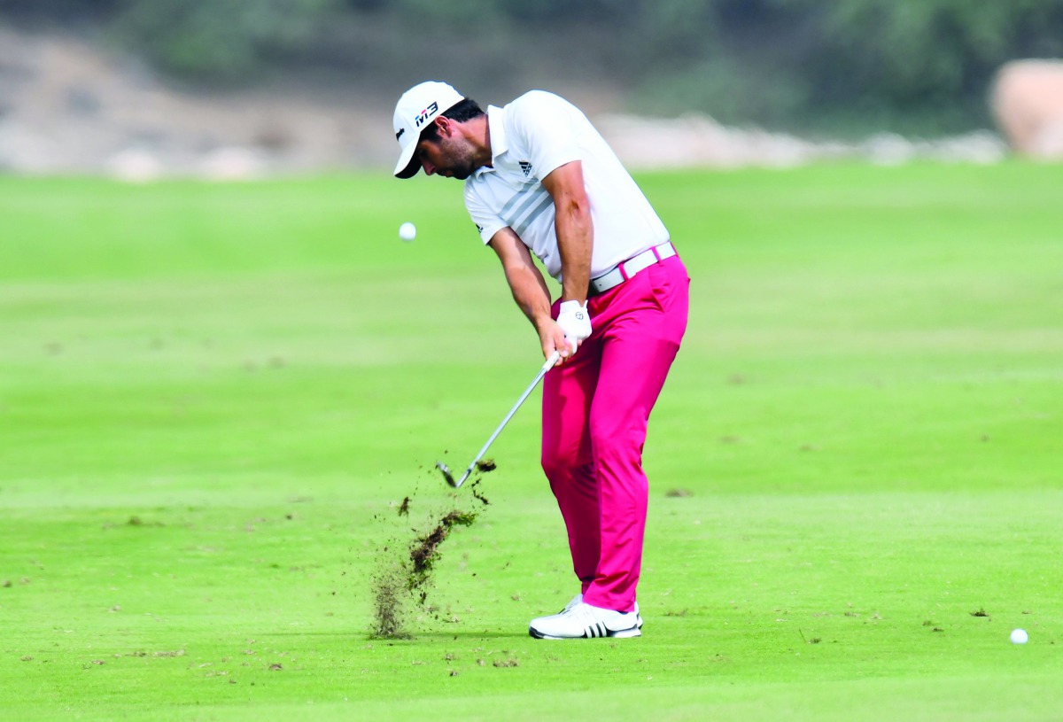 Adrian Otaegui of Spain plays a shot during the second round of the Qatar Masters golf tournament at the Doha Golf Club in Doha, yesterday.