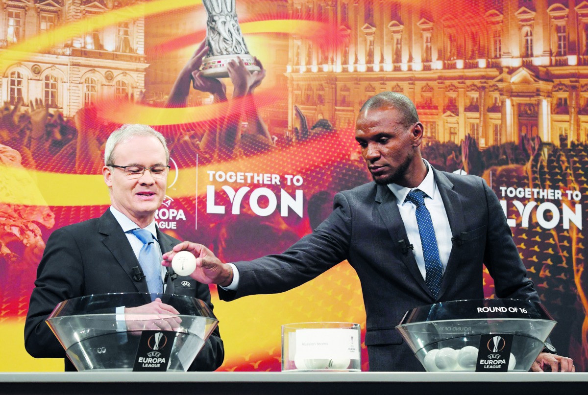 UEFA director of competitions Giorgio Marchetti (L) and Barcelona and Lyon's former player Eric Abidal attend the draw for the round of 16 of the UEFA Europa League football tournament at the UEFA headquarters in Nyon, Switzerland, on February 23, 2018.  