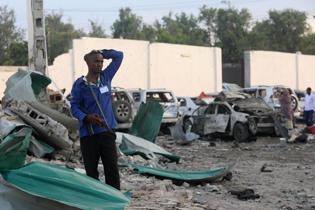 A security officer from Doorbin Hotel assesses the debris after a suicide car explosion in front of the hotel in Mogadishu, Somalia February 24, 2018. REUTERS/Feisal Omar