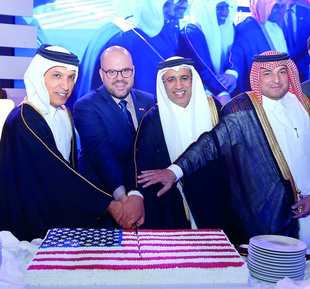 FROM LEFT: Minister of Finance H E Ali Shereef  Al Emadi, Ryan Gliha, Chargé d’Affaires, US Embassy; Minister of Justice H E Dr Hassan Lahdan Saqr Al Mohannadi, and Ambassador Ibrahim Fahkroo cutting cake at the US National Day celebrations, yesterday. 