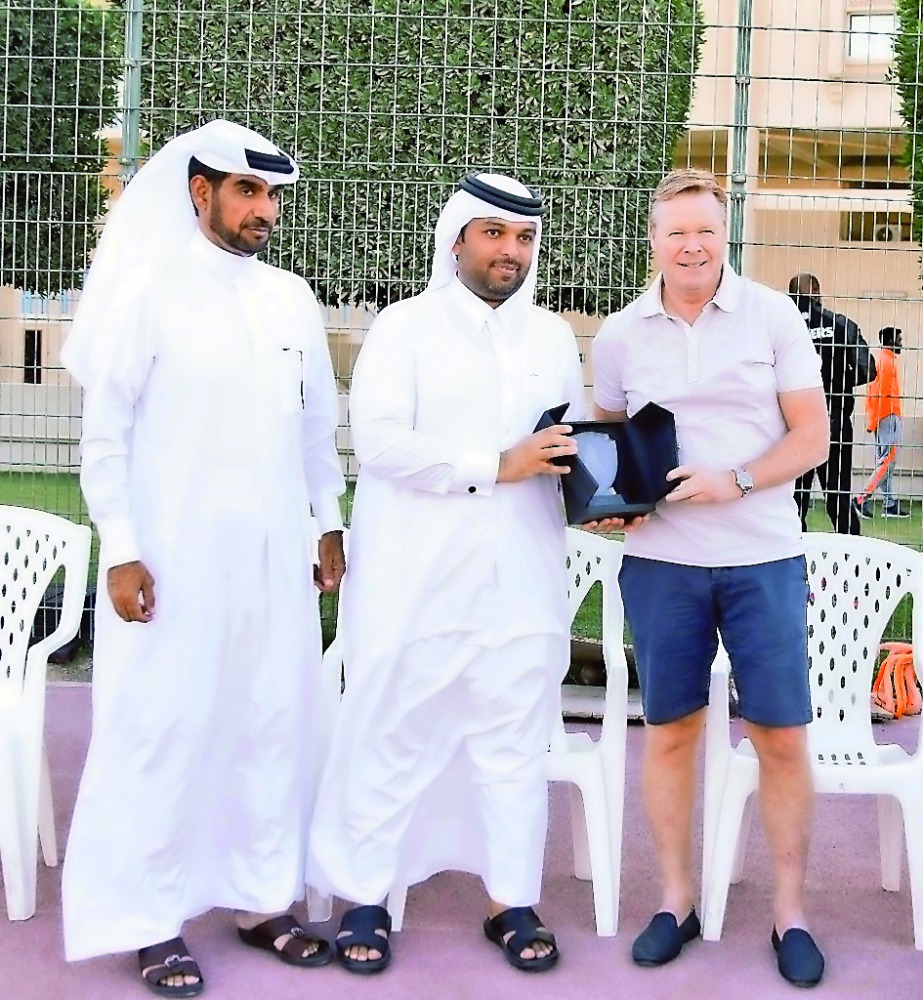 Officials of Al Gharafa SC presenting a souvenir to Netherlands coach Ronald Koeman during his visit to Qatar.