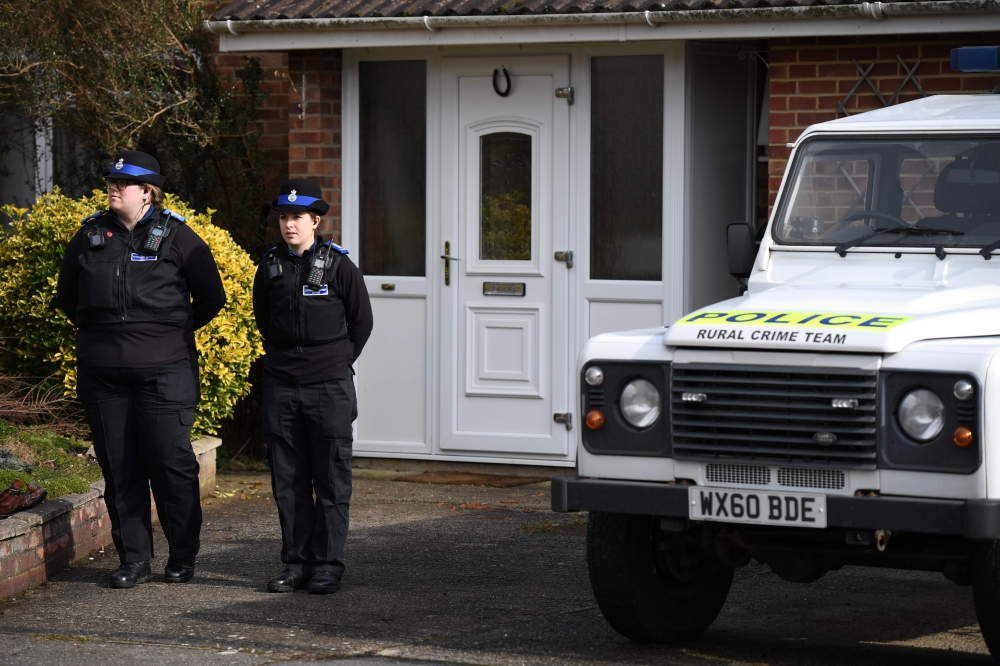 British Police Community Support Officers stand on duty outside a residential property in Salisbury, southern England, on March 6, 2018, believed to have been cordonned off in connection with the major incident which started at The Maltings shopping centr