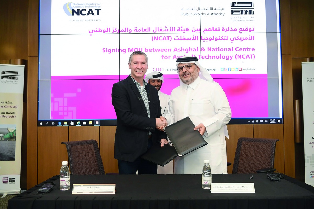 Eng. Saad bin Ahmed Al Muhannadi, President of Ashghal, exchanging documents with an official from the American National Center for Asphalt Technology after signing the MoU during the Fourth Road Workshop entitled “Recycling in Road Projects” at its headq