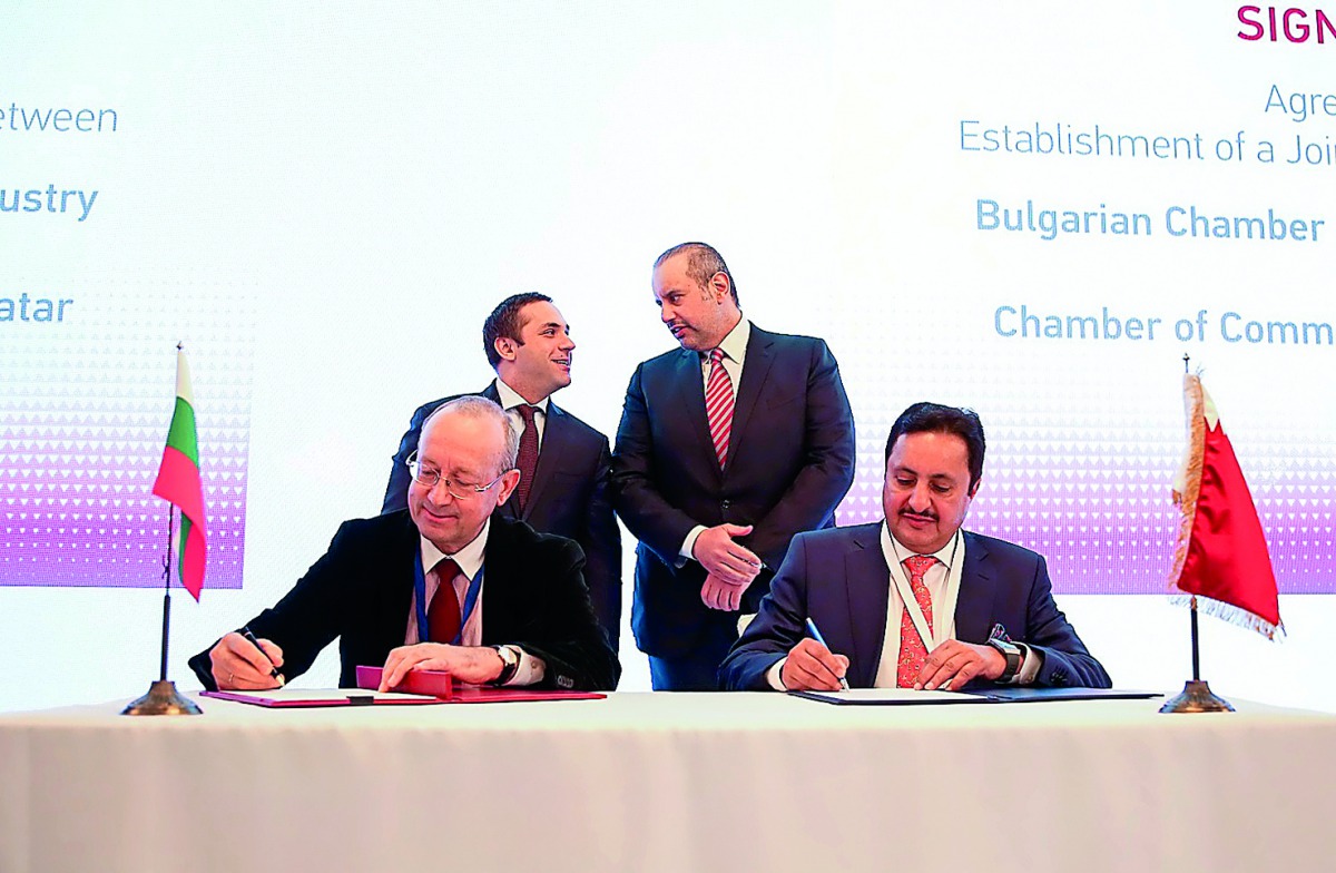 The Minister of Economy and Commerce H E Sheikh Ahmed bin Jassim Al Thani (standing right), and his Bulgarian counterpart Emil Karanikolov (standing left) witnessing the signing ceremony of an agreement signed by Sheikh Khalifa bin Jassim Al Thani (sittin