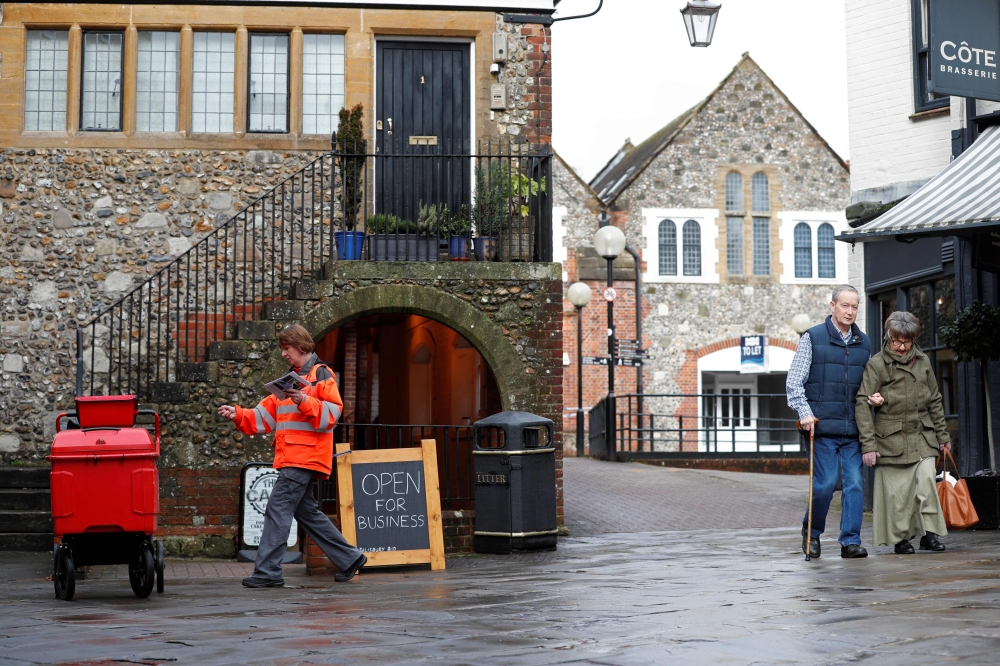 A Royal Mail postal workers delivers mail in Salisbury, southern England, on March 12, 2018, near to where a man and woman were found critically ill on March 4, after being apparently poisoned with what was later identified as a nerve agent sparking a maj