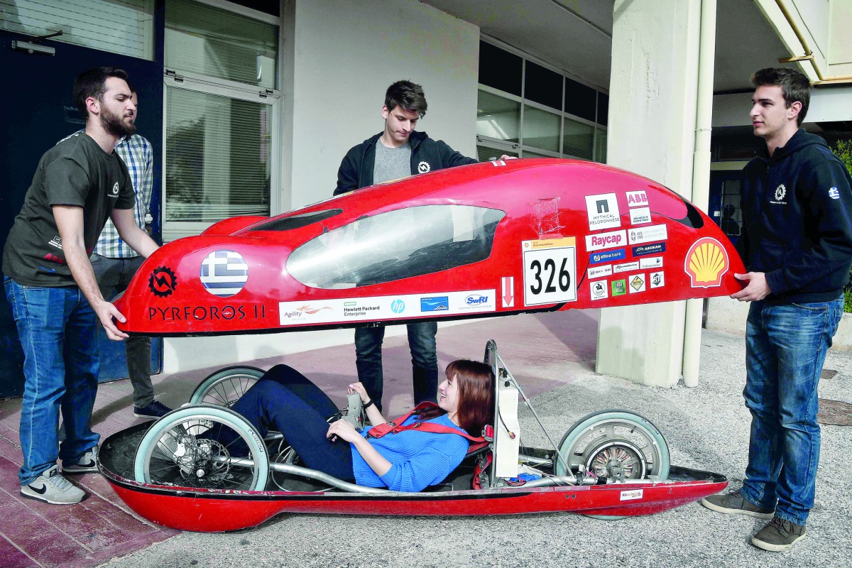 Students prepare to try their electric car prototype called Pyrforos at the Polytechnic School of Athens campus on March 6, 2018. AFP / Louisa Gouliamaki