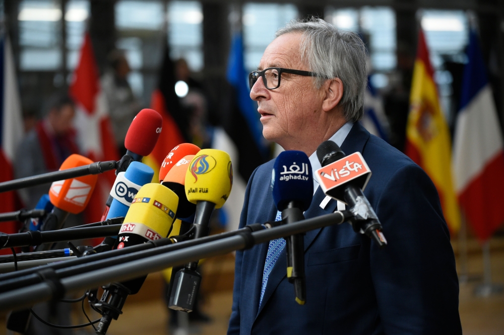 European Commission President Jean-Claude Juncker speaks to the press as he arrives on the first day of a summit of European Union (EU) leaders at the EU headquarters in Brussels, on March 22, 2018. / AFP / JOHN THYS