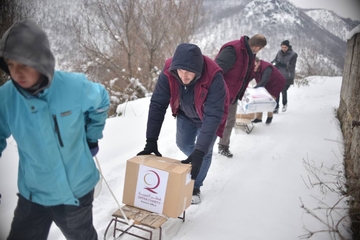 Qatar Charity volunteers transport materials for poor people in Kosova. 