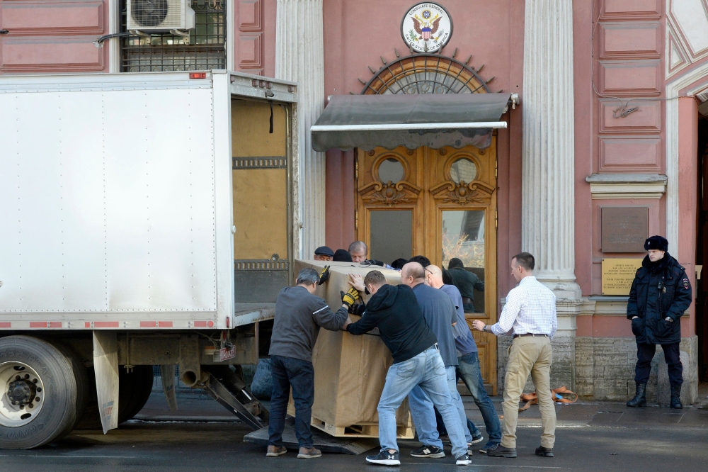 Employees of the US Consulate and removal men load in a truck belongings and objects of the US Consulate in Saint Petersburg on March 31, 2018.  AFP / Olga Maltseva