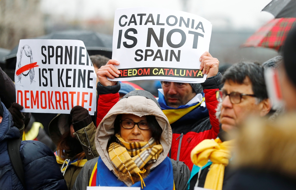 Protesters hold posters during a demonstration organised by the pro-independence association ANC (National Assembly of Catalonia) to demand the release of former Catalan regional president Carles Puigdemont who is detained in a prison in Germany, in Berli