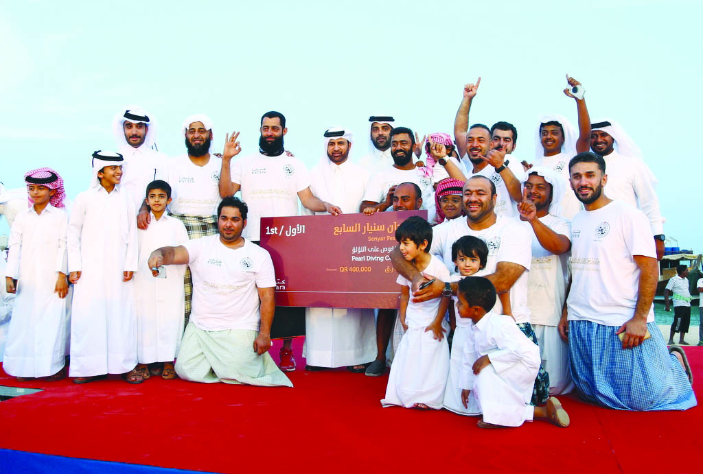 Katara General Manager Dr Khalid bin Ibrahim Al Sulaiti (centre), with the winners of the pearl diving championship, which is part of Katara’s annual Senyar Festival 2018, at Katara beach, yesterday.