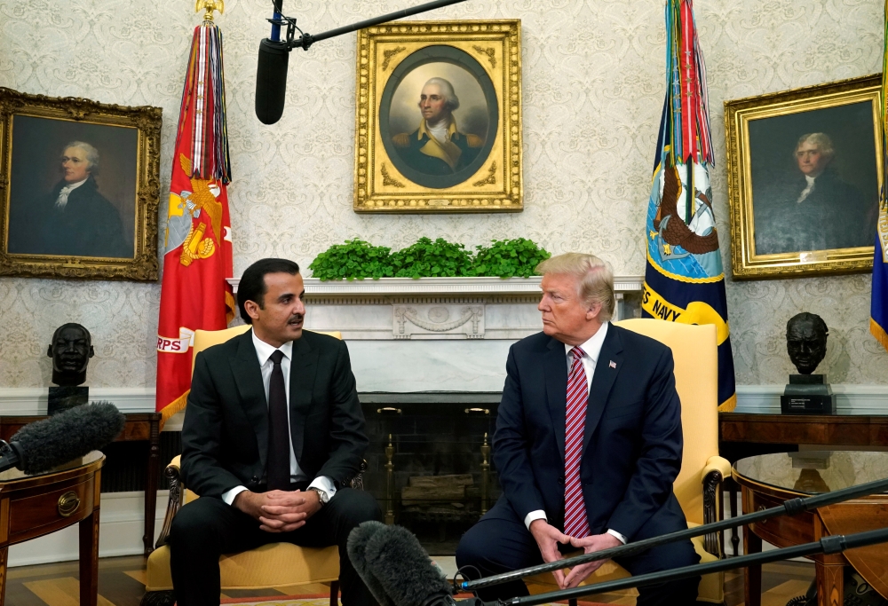 U.S. President Donald Trump meets The Emir H H Sheikh Tamim bin Hamad Al Thani in the Oval Office at the White House in Washington. U.S., April 10, 2018. REUTERS/Kevin Lamarque
