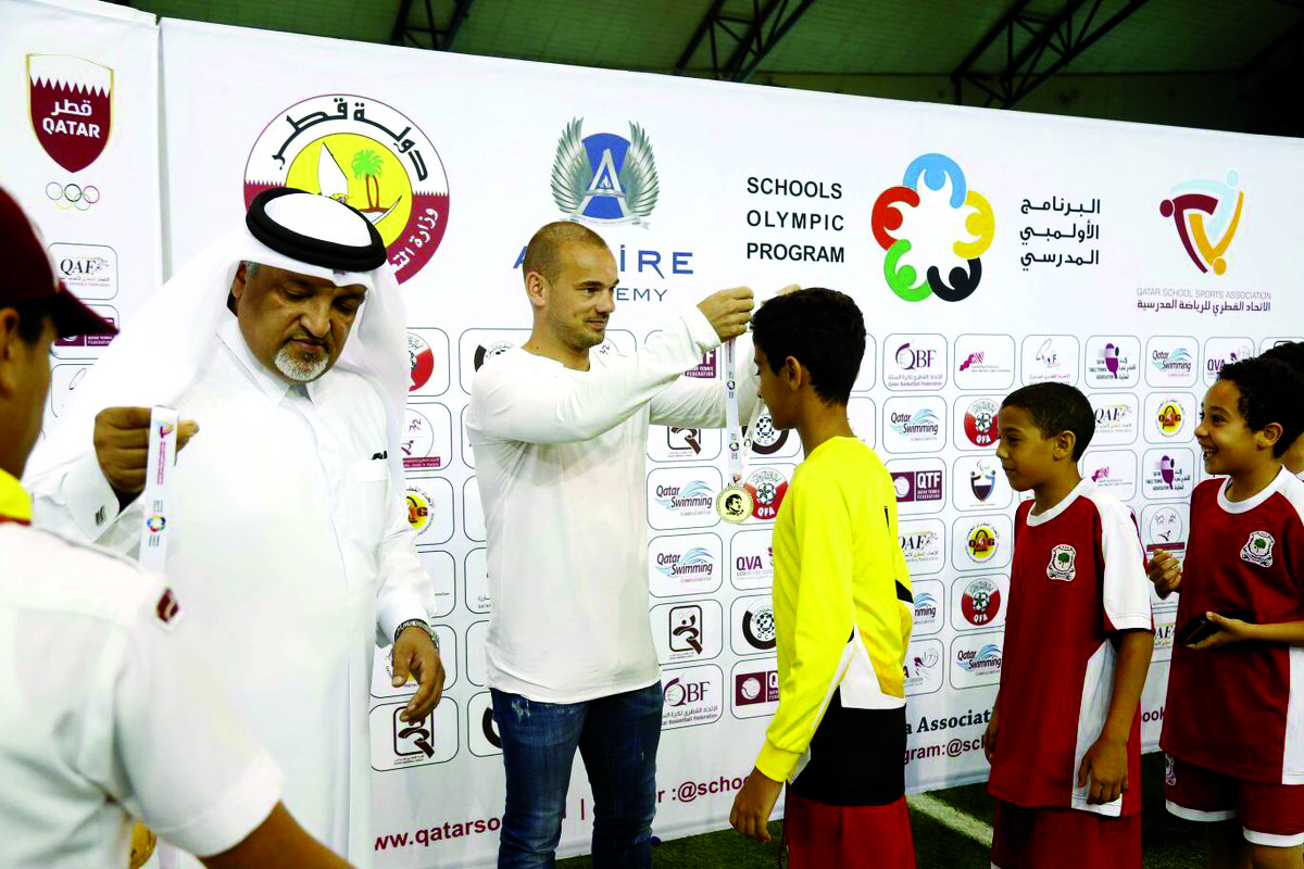 Al Gharafa player and former Dutch international football er Wesley Sneijder giving away a medal during the prize distribution ceremony.