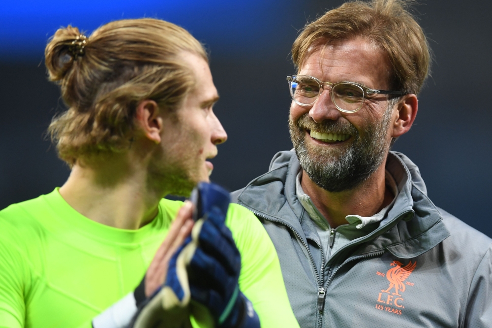 Liverpool's German goalkeeper Loris Karius (L) and Liverpool's German manager Jurgen Klopp react following the UEFA Champions League second leg quarter-final football match between Manchester City and Liverpool, at the Etihad Stadium in Manchester, north 