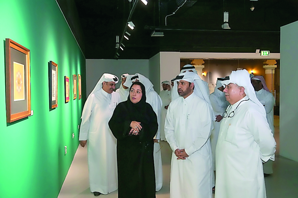 Qatari artist Iman Al Saad (second left); Katara General Manager, Dr. Khalid bin Ibrahim Al Sulaiti (second right) and other officials at the opening of the solo exhibition “Words of Gold” at Katara Building 22 on Monday.