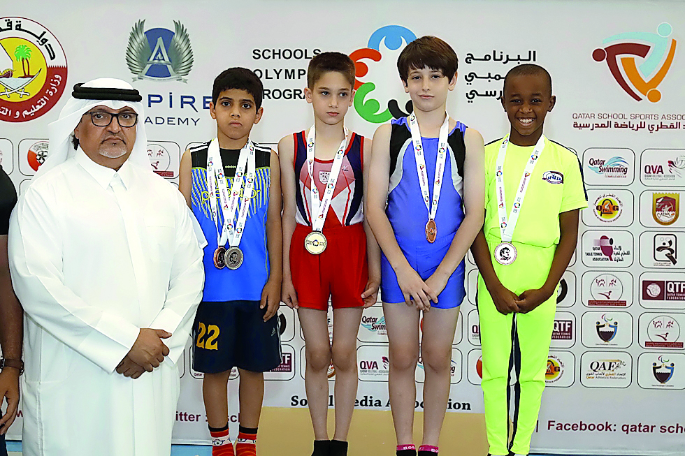 Qatar Gymnastics Federation President, Ali Al Hitmi poses for a photograph with podium winners of artistic gymnastics  competitions for primary and preparatory schools (boys)  at the prestigious 11th Schools Olympic Program 2018 (SOP) during the presentat