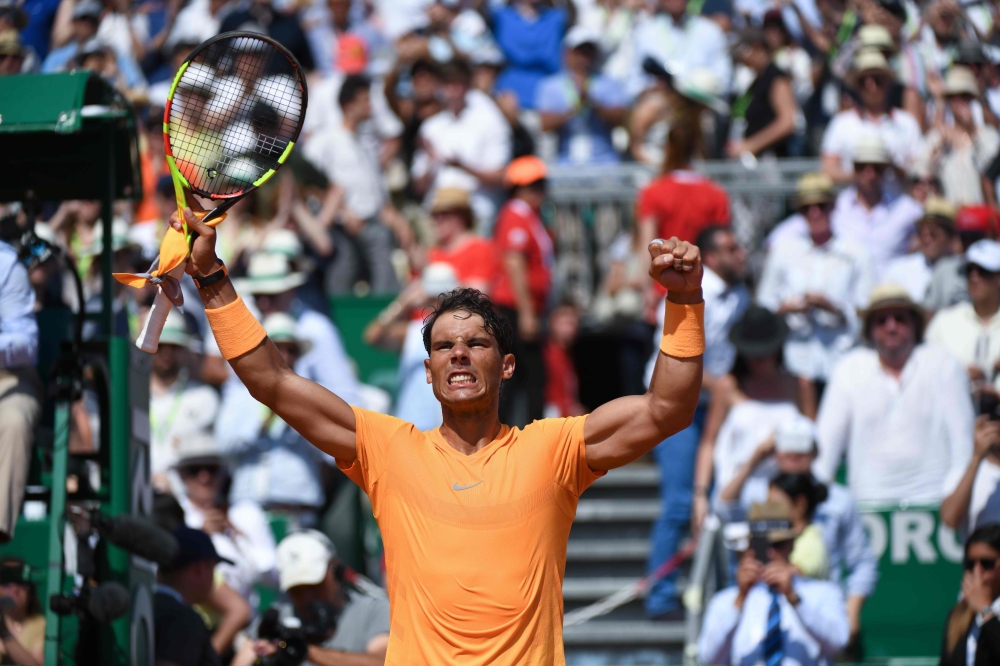 Spain's Rafael Nadal celebrates after his victory against Bulgaria's Grigor Dimitrov during their semi-final match at the Monte-Carlo ATP Masters Series tournament on April 21, 2018 in Monaco. / AFP / YANN COATSALIOU
