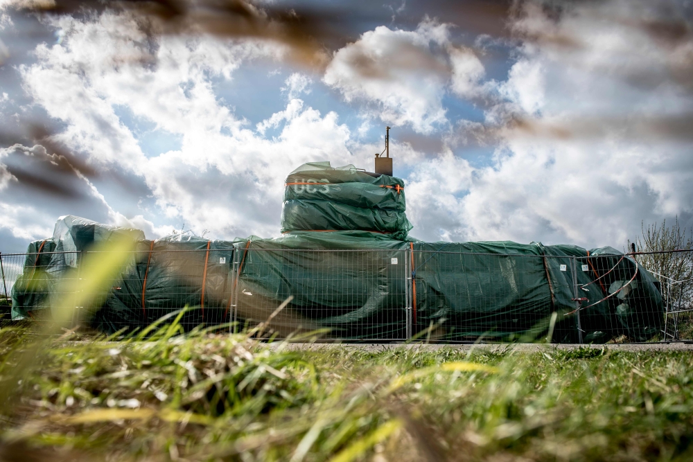 The homemade submarine UC3 Nautilus as it is covered with green tarpaulin in Nordhavn, a harbour area in Copenhagen, Denmark on April 25, 2018.  AFP / Ritzau Scanpix / Mads Claus Rasmussen