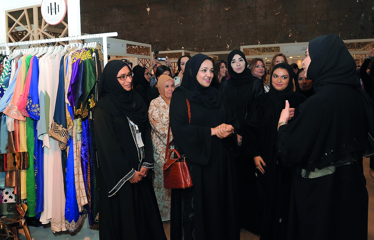 Dr Sheikha Aisha bint Faleh bin Nasser Al Thani, with other guests, touring the13th Heya Arabian Fashion Exhibition, after its opening at the Doha Exhibition and Convention Center, yesterday. RIGHT: Fashion Show as part of the exhibition    Pic: Salim Mat