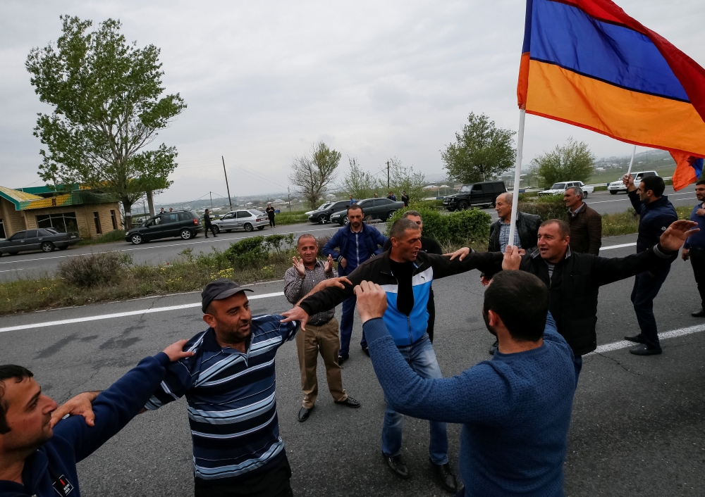 Local residents dance as they wait for arrival of supporters of Armenian opposition leader Nikol Pashinyan on their way to Ijevan, in the town of Abovyan, Armenia April 28, 2018. REUTERS/Gleb Garanich
