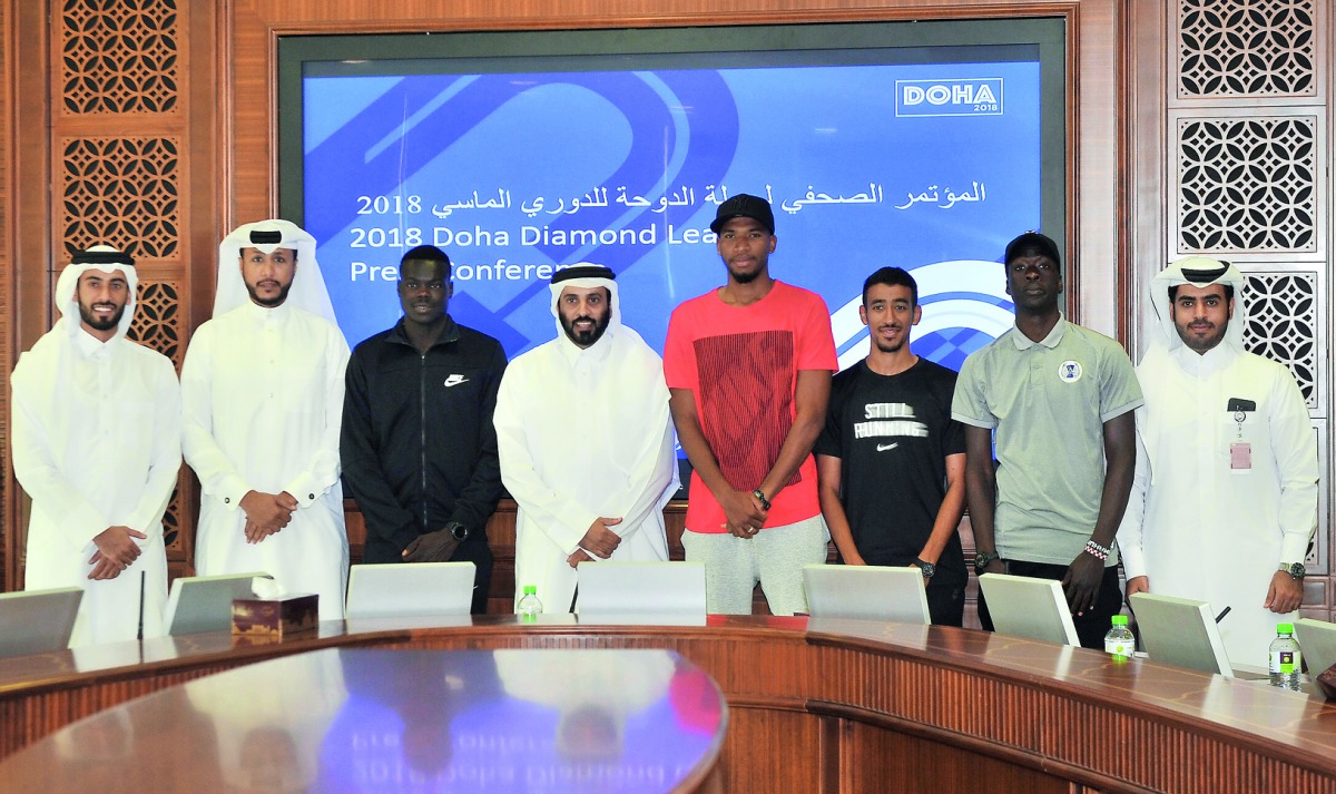 Hamad Issa Al Fadalah (centre), Secretary-General of Qatar Athletics Federation (QAF) poses for a photograph with QAF officials and some of the star Qatari athletes during a press conference held at Qatar Olympic Committee headquarters yesterday. Picture: