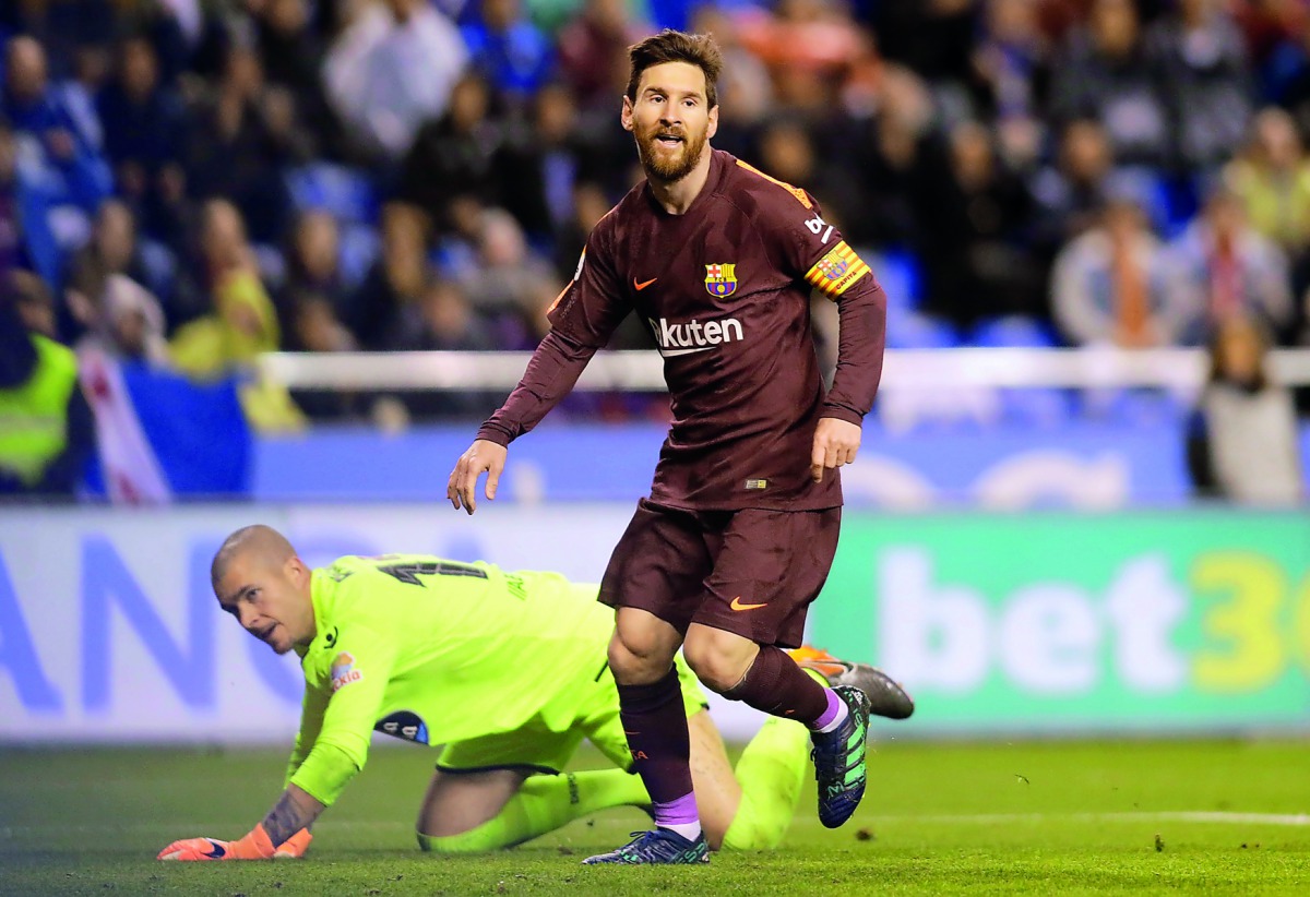 Barcelona's Lionel Messi celebrates scoring their third goal as Deportivo de La Coruna's Ruben looks dejected. Reuters/Miguel Vidal
