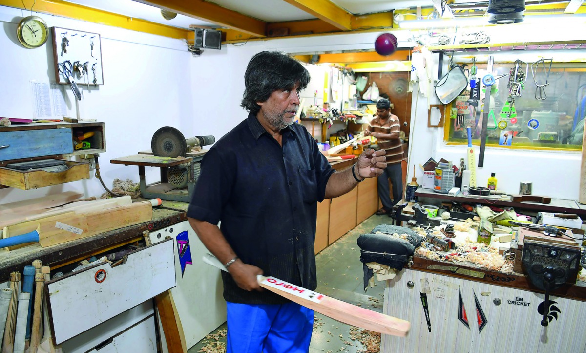 This picture taken on April 23, 2018, shows Indian bat maker Aslam Chaudhry checking the bounce of a cricket bat at his workshop in Mumbai. When the IPL’s big-hitters need their favourite bats urgently repaired, there’s one person they all call upon -- Ch
