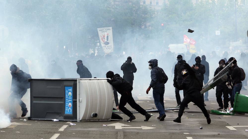 Masked protesters throw stones during clashes with French CRS riot forces at the May Day in Paris, France on May 01, 2018. ( Zakaria - Anadolu Agency )
