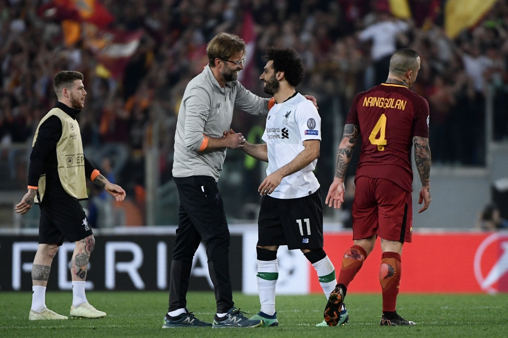 Liverpool's German manager Jurgen Klopp celebrates with Liverpool's Egyptian midfielder Mohamed Salah at the end of the UEFA Champions League semi-final second leg football match between AS Roma and Liverpool at the Olympic Stadium in Rome on May 2, 2018.