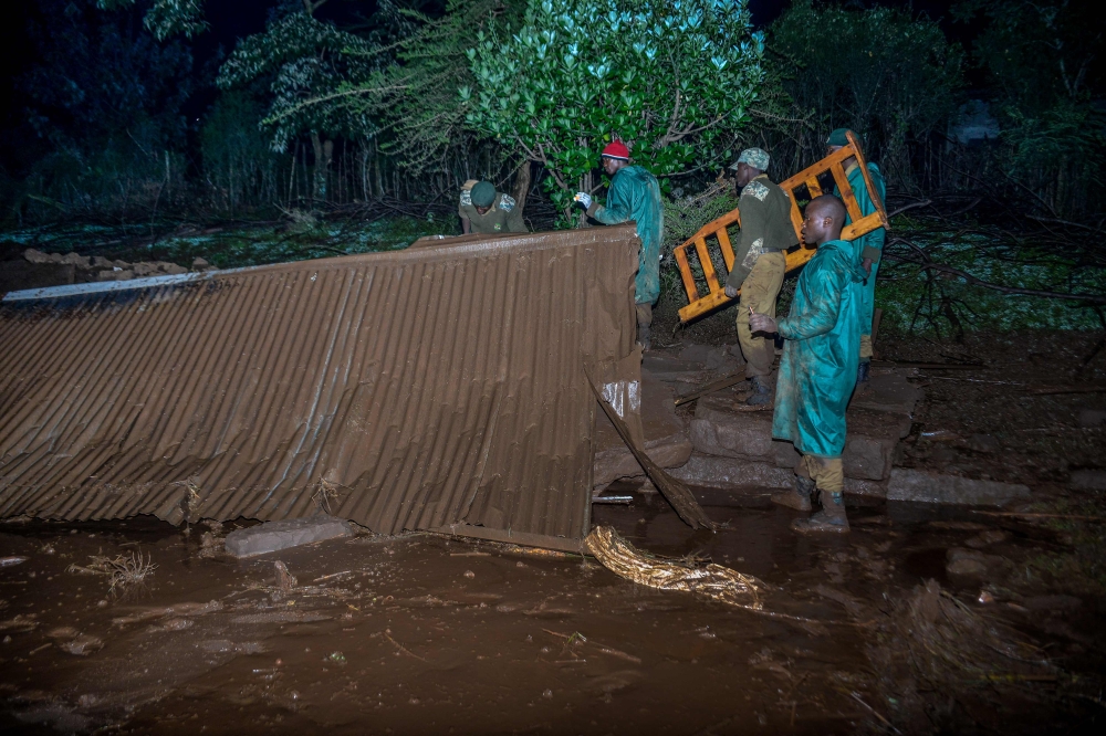 Volunteers search for survivers in a residential area after Patel dam burst its bank at Solai, about 40 kilometres north of Nakuru, Kenya, on May 10, 2018. AFP