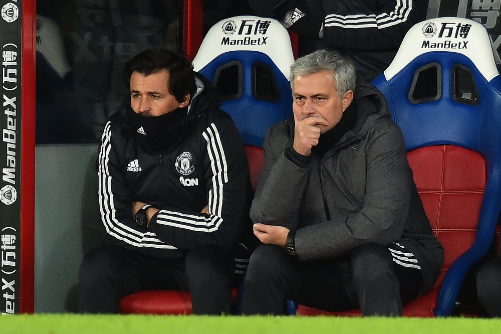 (FIles) In the file picture taken on March 5, 2018, Manchester United's Portuguese manager Jose Mourinho (R) sits beside his assistant, Rui Faria in the dugout during the English Premier League football match against Crystal Palace at Selhurst Park in sou