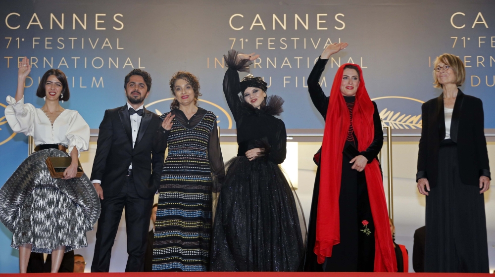 Cast members Behnaz Jafari and Marziyeh Rezaei pose with director Jafar Panahi's daughter Solmaz and son Panah and France's Minister of Culture Francoise Nyssen. REUTERS/Jean-Paul Pelissier