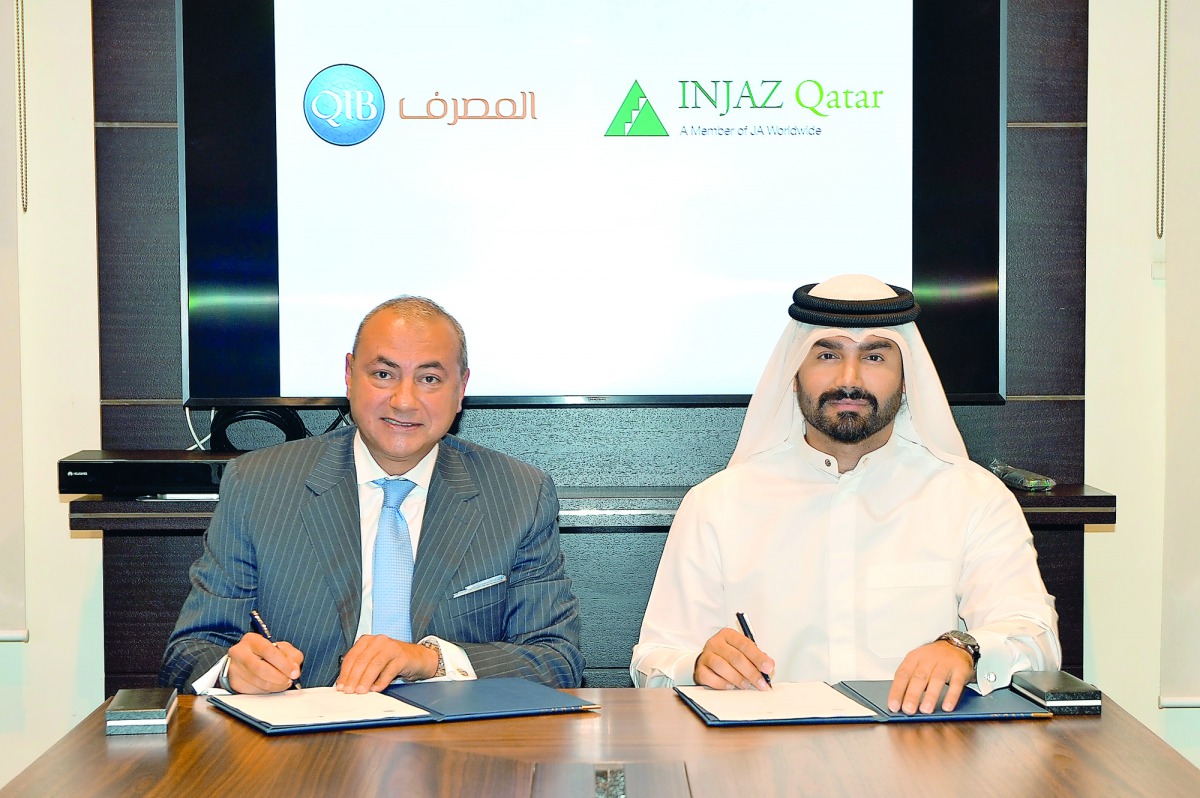 Bassel Gamal (left), QIB Group CEO, and Emad Al Khaja, INJAZ Qatar CEO, during the signing ceremony at the bank’s headquarters.
