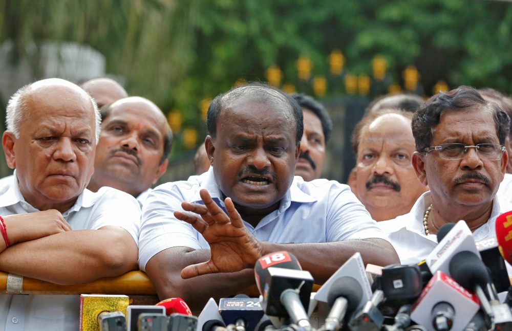 HD Kumaraswamy (C), Janata Dal (Secular) leader and former Chief Minister of the southern state of Karnataka, speaks with the media after handing over a letter of support from elected legislators to the state governor, outside the governor's house in Beng