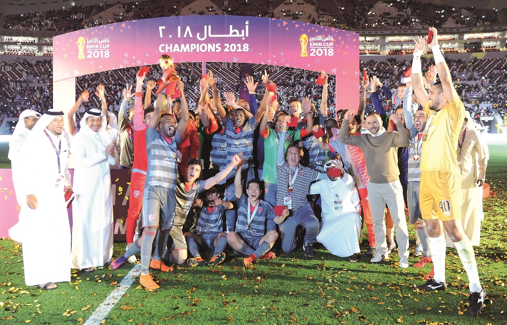 Al Duhail players and officials celebrate after winning the 2018 Amir Cup final at the Khalifa International Stadium in Doha yesterday. Pictures: Abdul Basit / The Peninsula  