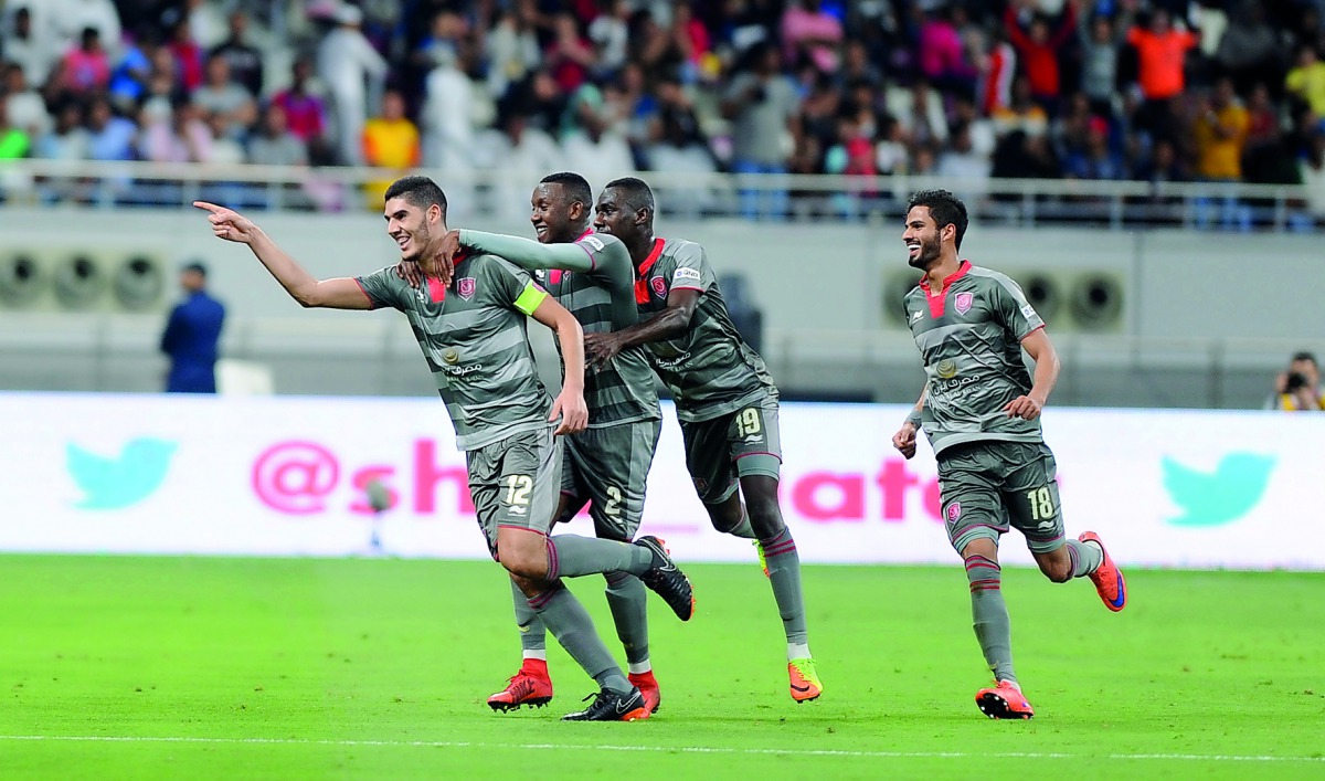 Al Duhail captain Karim Boudiaf (left) along with team-mates celebrates after scoring a goal against Al Rayyan during their Amir Cup final on Saturday. 