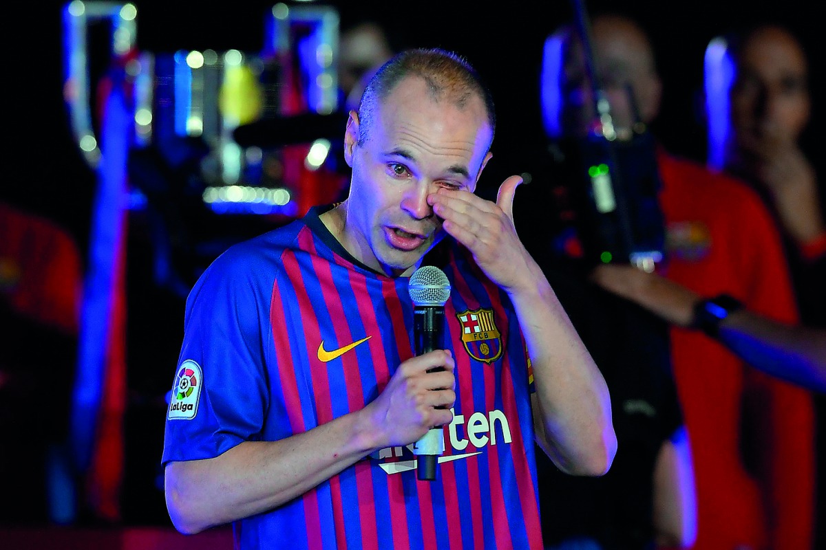 Barcelona's Spanish midfielder Andres Iniesta wipes his tears during a tribute after the Spanish league football match between FC Barcelona and Real Sociedad at the Camp Nou stadium in Barcelona on May 20, 2018.  AFP / Lluis Gene