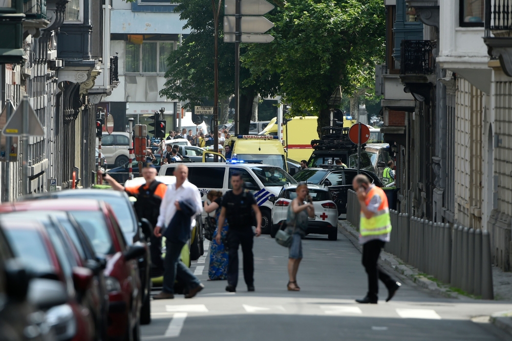 Police and ambulance are seen at the site where an armed man shot and killed police officers before being subdued by police in the eastern Belgian city of Liege on May 29, 2018. / AFP / JOHN THYS