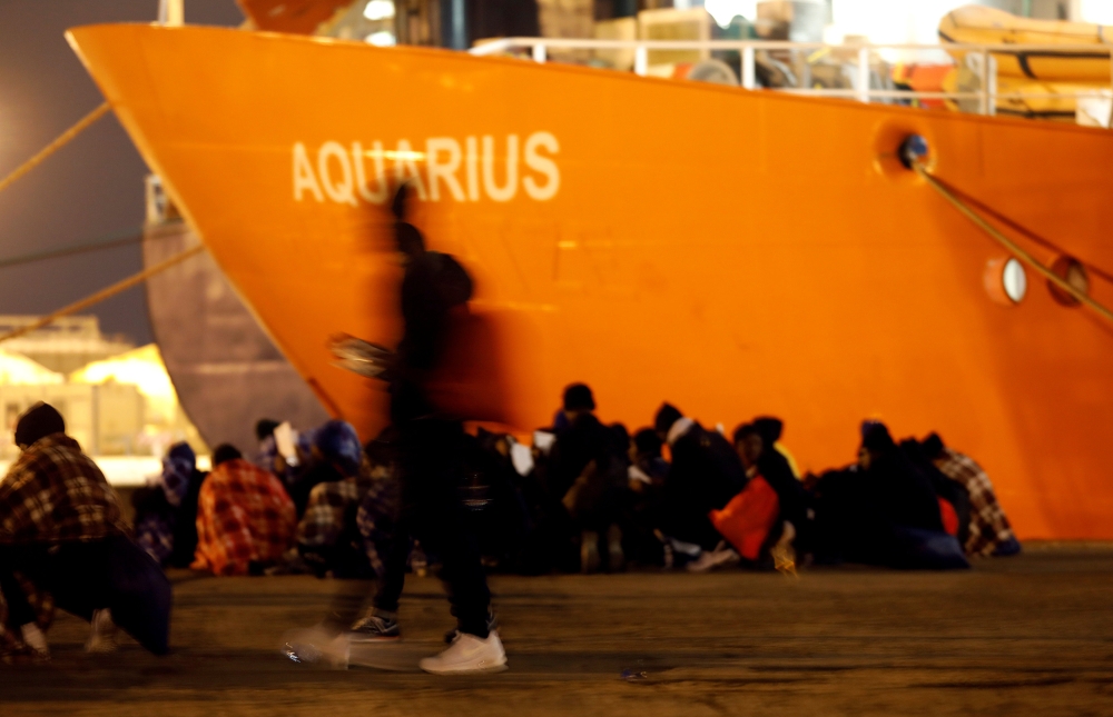 Migrants disembark from the MV Aquarius, a search and rescue ship run in partnership between SOS Mediterranee and Medecins Sans Frontieres, after it arrived in Augusta on the island of Sicily, Italy, January 30, 2018. Reuters/Antonio Parrinello