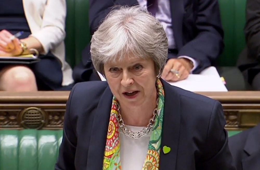 A video grab from footage broadcast by the UK Parliament's Parliamentary Recording Unit (PRU) shows Britain's Prime Minister Theresa May as she answers questions on the G7 summit, in the House of Commons in London on June 11, 2018. AFP PHOTO / PRU