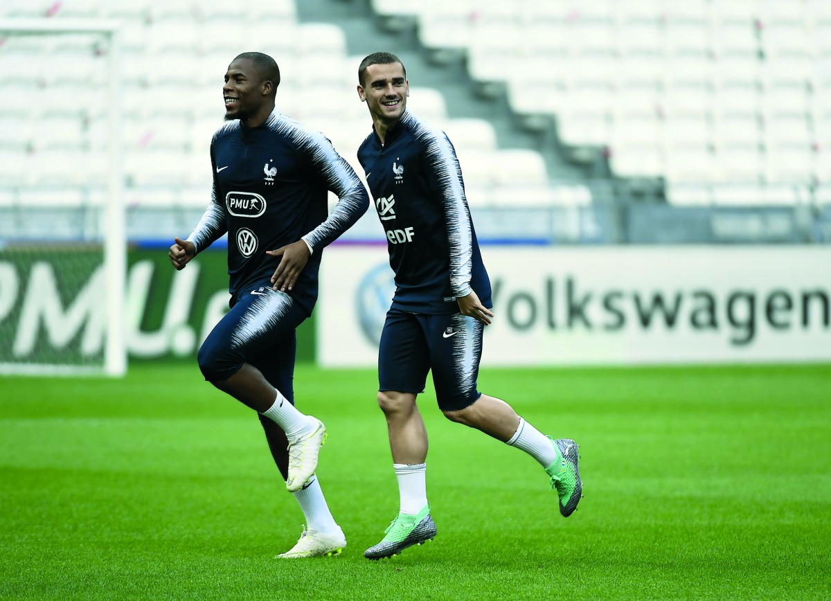 French national players Antoine Griezman (R) and Djibril Sidibe run during a training session, on June 8, 2018, at the Groupama Stadium in Decines-Charpieu near Lyon, central-eastern France, on the eve of the international friendly football match against 