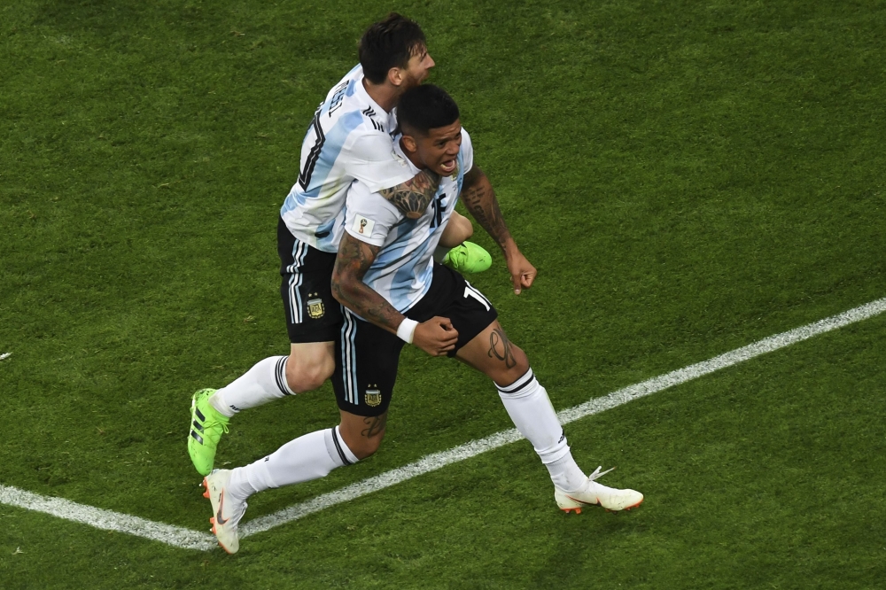 Argentina's defender Marcos Rojo (R) celebrates, with Argentina's forward Lionel Messi, scoring a goal during the Russia 2018 World Cup Group D football match between Nigeria and Argentina at the Saint Petersburg Stadium in Saint Petersburg on June 26, 20